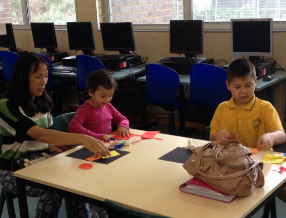 Parents working with students in the library