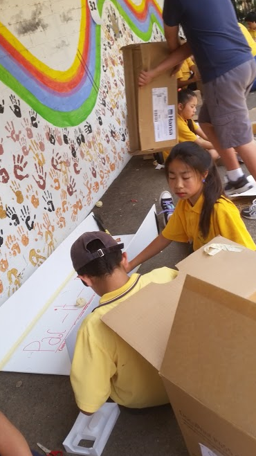 Kids playing with cardboard