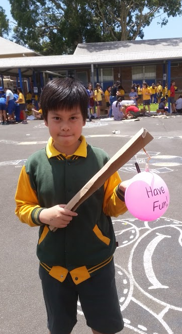 Student with balloon that says have fun